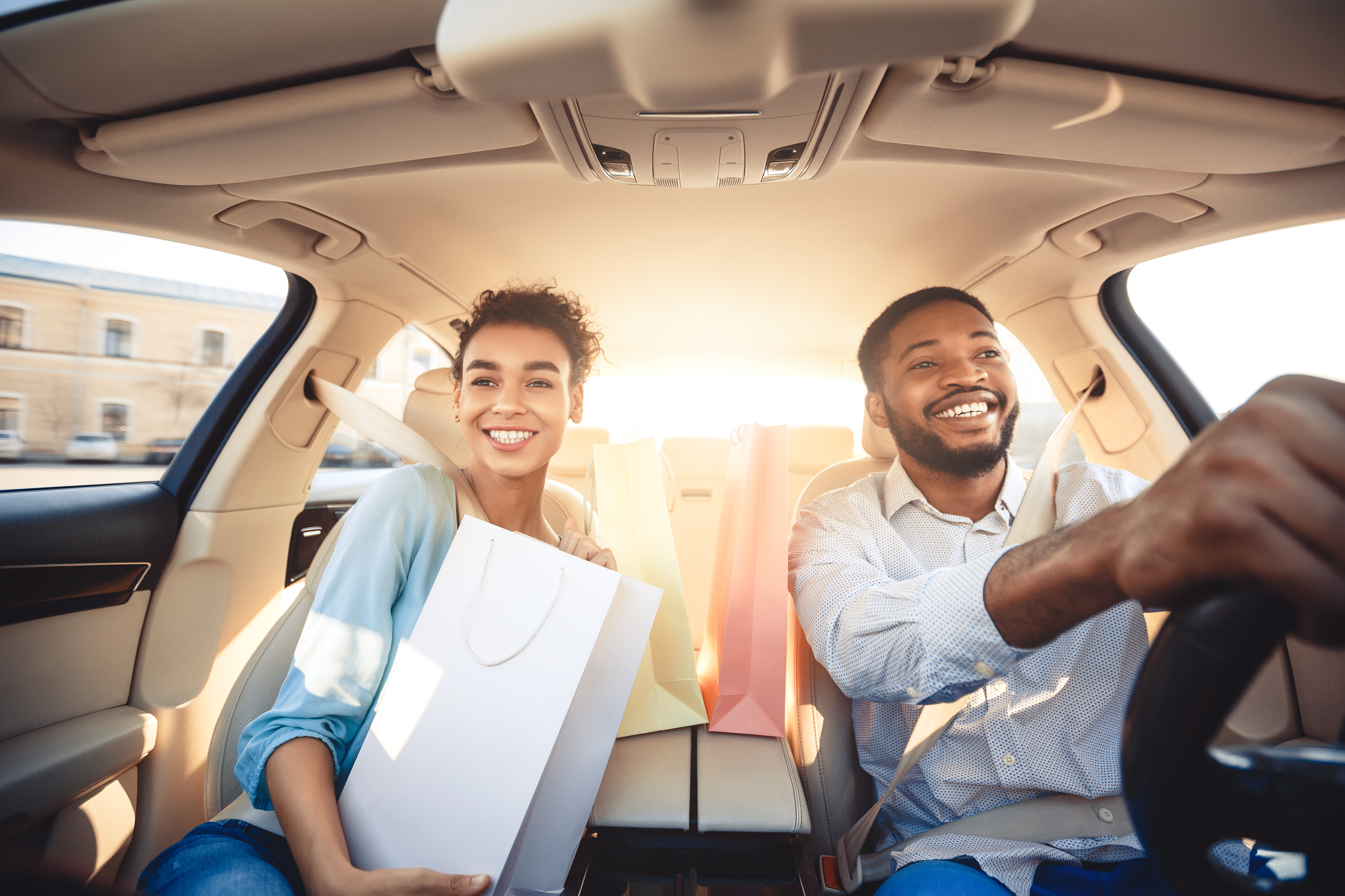 couple driving home in car with shopping bags 2021 08 26 16 33 39 utc